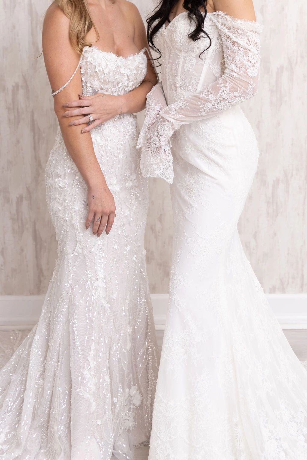 Two brides wearing wedding gowns